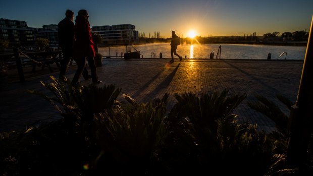Sun rises over Lake Burley Griffin.