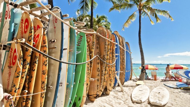 Surfboards lined up in the rack at famous Waikiki Beach in Honolulu.