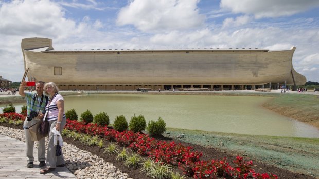There's no age limit for selfies: Visitors take a selfie as a replica Noah's Ark stands in the distance at the Ark Encounter theme park in Williamstown, US.