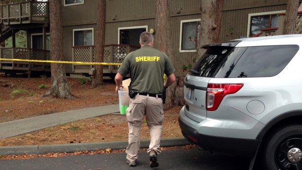 Investigators are seen at the apartment complex that has been tied to Arcan Cetin, the suspected Cascade Mall shooter, in Oak Harbor, Washington.