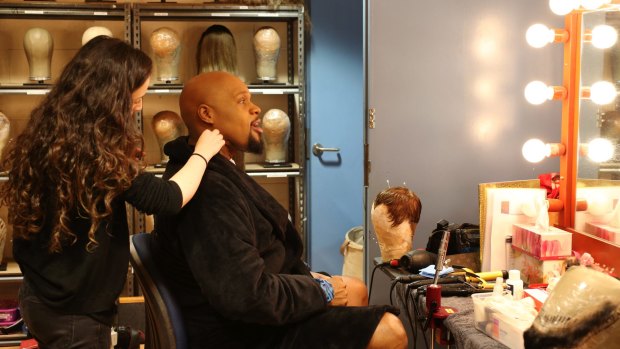 Michael James Scott, who plays the Genie, behind the scenes putting on makeup in Aladdin. 