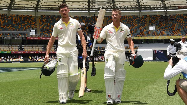 Australian openers David Warner (right) and Cameron Bancroft walk from the Gabba on day five of the first Test.
