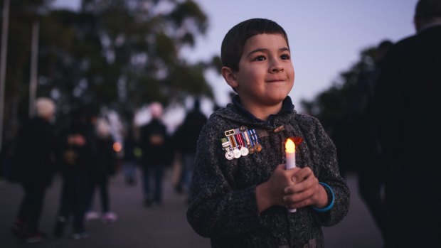 Luke Piontek, 6, wearing the medals of his uncle, Luke Worsley, who died in Afghanistan in 2007, at the Anzac Day Dawn Service.