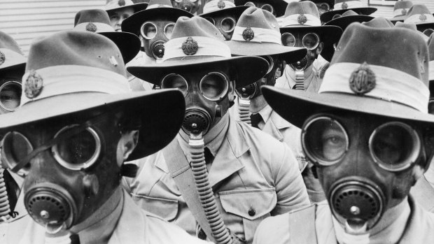 Australian soldiers sport gas masks in World War II.