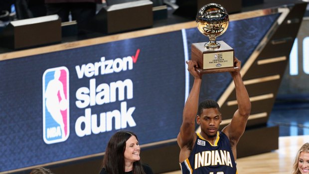 Standing tall: Glenn Robinson III lifts the NBA Slam Dunk trophy.
