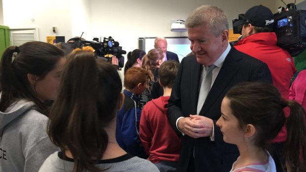 Communications Minister Mitch Fifield speaking with students at Merri Creek Primary School in Melbourne.
