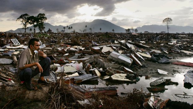 Horror holiday: An Acehnese man lingers at the ruins in Banda Aceh in 2005.