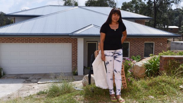 Evangeline Love in front of her new house in Winmalee, two years after a major bushfire destroyed many homes on her street.