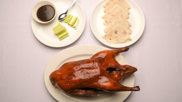 The signature Peking duck is presented tableside, then whisked off and assembled into pancakes.