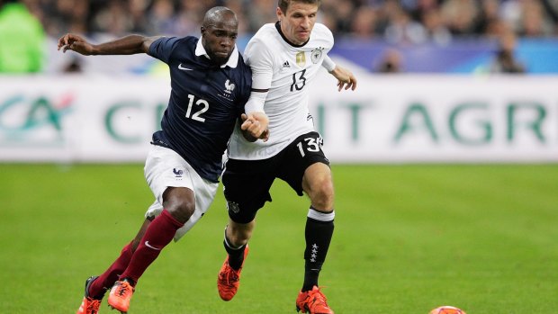 French footballer Lassana Diarra competes with German opponent Thomas Mueller during the match.