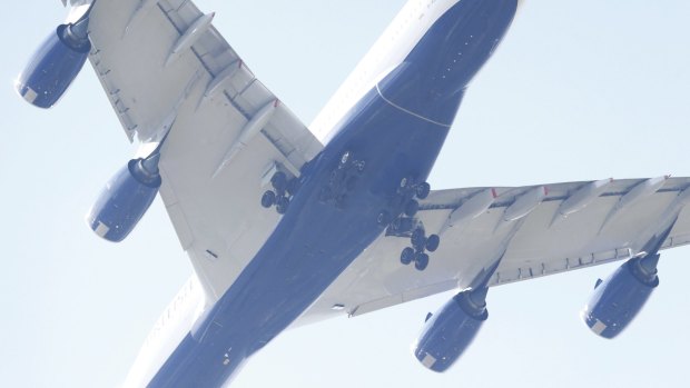 A British Airways 747 with it's undercarriage deployed approaches Heathrow Airport over Richmond where the body of a suspected suspect was found in west London.