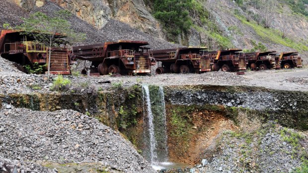 Heavy trucks sit rusting on the edges of Panguna copper mine, closed in 1989 as a result of sabotage.