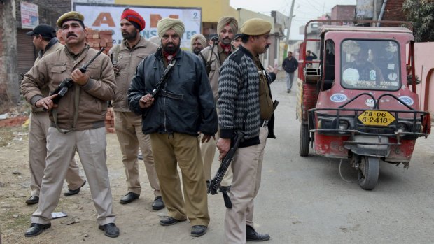 Indian policemen patrol at a residential area near the Indian air force base in Pathankot on Monday. 
