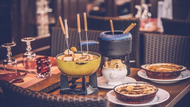 Parisian street cafe with an earthenware pot (caquelon) for fondue.