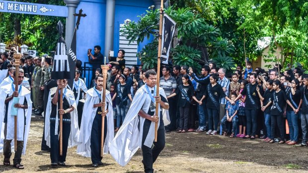 The elders of a local Roman Chatolic chapel march in a Holy Week procession in Larantuka town, Flores.