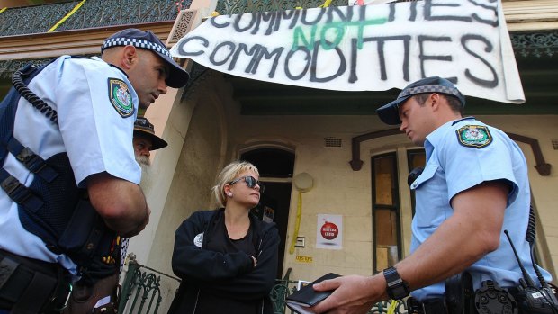 "A farce": Tayce, 27, speaks with police in Millers Point. 