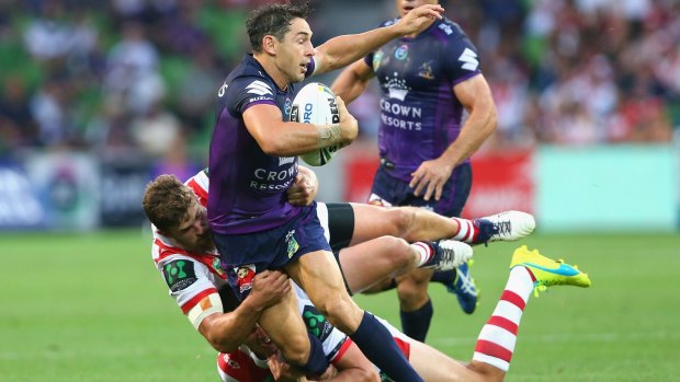 Billy Slater is tackled by Gareth Widdop and Will Matthews in his maiden NRL appearance this year.