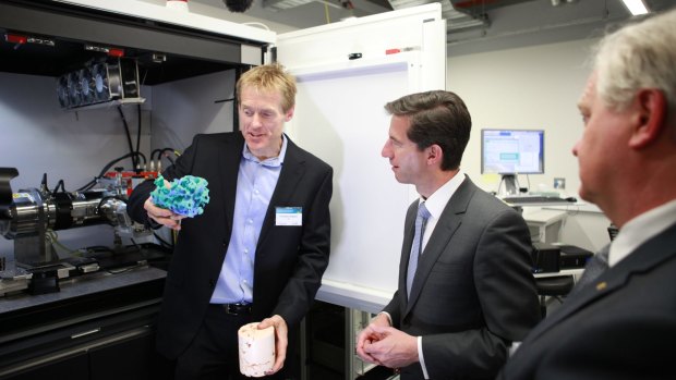 Associate Professor Adrian Sheppard, the Head of the ANU Department of Applied Mathematics, left, shows Minister for Education Simon Birmingham, a 3D model of rock formations at the opening of the refurbished CTLab.