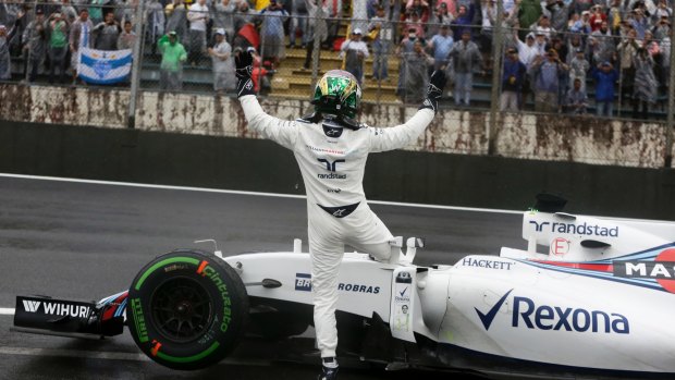Brazilian Felipe Massa waves to the crowd after crashing during the Brazilian grand prix on Sunday.