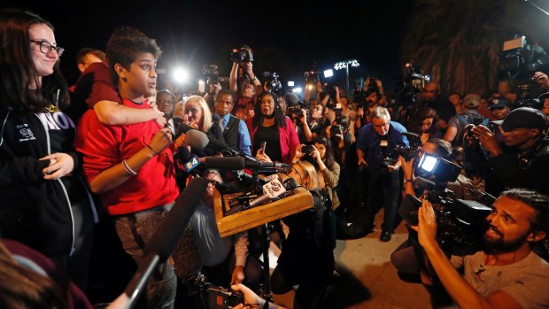 Tanzil Philip, 16, left, makes a passionate speech to supporters in Florida.
