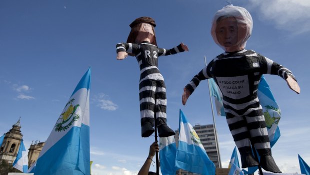Demonstrators hold effigies representing Guatemala's President Otto Perez Molina, right, and former vice-president Roxana Baldetti at a protest in Guatemala City at the weekend. 