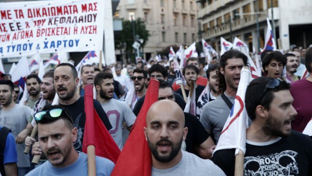 Members of the Communist-affiliated PAME labor union shout slogans during an anti-austerity rally in Athens, Wednesday.
