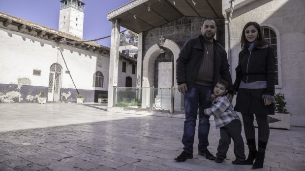 Human cost: St Sarkis deacon Harout Atokanian with his wife, Zepur, and surviving son Nareg; the family lost six-year-old Hovanes in a rebel attack.