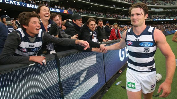 Emerging favourite: Patrick Dangerfield celebrates after the game with Cats fans.