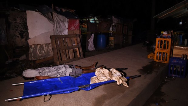 The body of Rolito Nunez lays on a footpath in Quezon City after he and another man were executed by six unidentified men on motorbikes on April 18. 