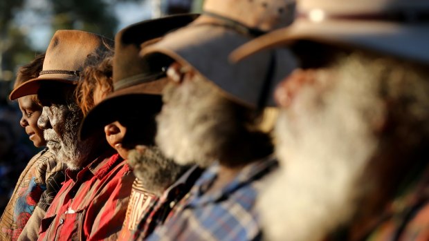 Mutitjulu elders watch performers from Muakgau Lak Gubau Gizu during the opening ceremony of the convention. 