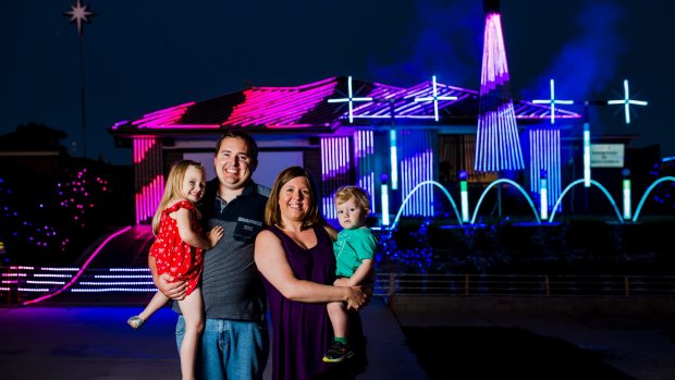 James Petterson with his wife Sarah, and children Rachel 4, and Andrew 1. The Petterson's light installation has more than 30,000 LED bulbs.