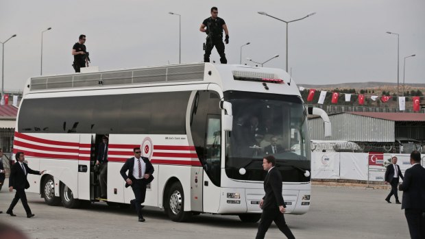 High security: The bus carrying German Chancellor Angela Merkel, Turkish Prime Minister Ahmet Davutoglu, European Union Council president Donald Tusk, and EU Commission vice-president Frans Timmermans arrives at the Nizip refugee camp.