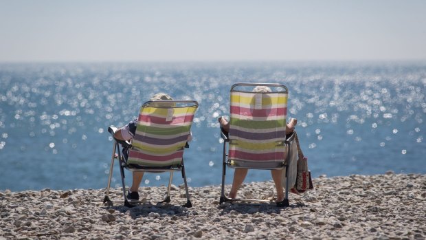I do like to be beside the seaside: Beachgoers soak up the sun in Lyme Regis in Dorset, England. Parts of Britain are enjoying a blast of warm continental air and sunshine, which forecasters say could deliver the hottest May temperatures since World War II. 