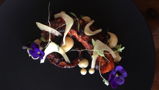 The octopus dish at Wooden Horse made pretty with violas and micro herbs.
