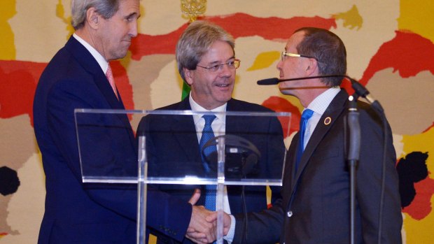 US Secretary of State John Kerry, left, Italian Foreign Minister Paolo Gentiloni, centre, and UN special envoy for Libya Martin Kobler shake hands after announcing their national unity plan for Libya in Rome.