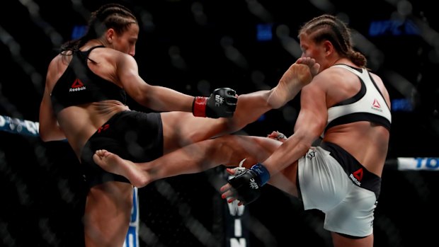 Trading blows: Karolina Kowalkiewicz of Poland (right) fights compatriot Joanna Jedrzejczyk in their women's strawweight championship bout.