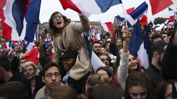 Supporters celebrate after Emmanuel Macron's victory is announced.