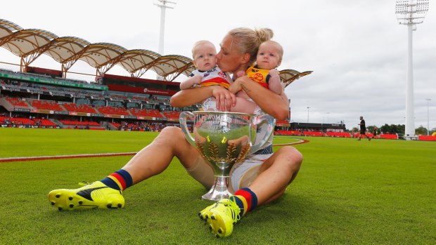 Adelaide's Erin Phillips celebrates her side's AFLW premiership win with her twins Blake and Brooklyn.