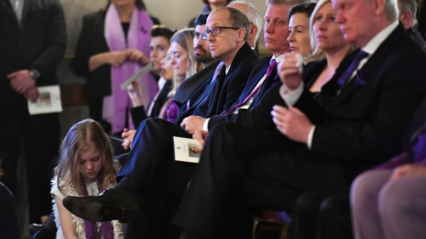 Fiona Richardson's husband Stephen Newnham (centre) and daughter Catherine, at his feet, at the MP's state memorial service.