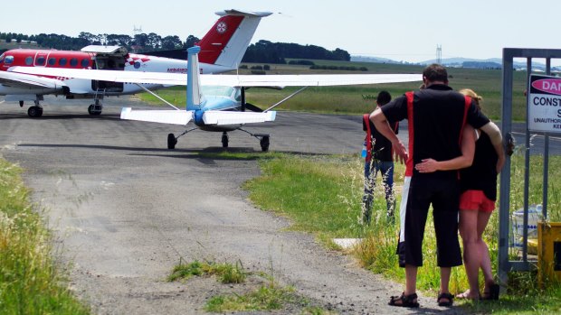 Witnesses comfort each other at Goulburn airport.