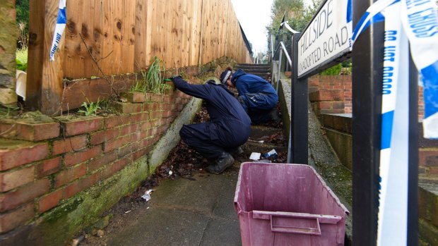 Police officers search the area around the home of former <em>EastEnders</em> actress Sian Blake.