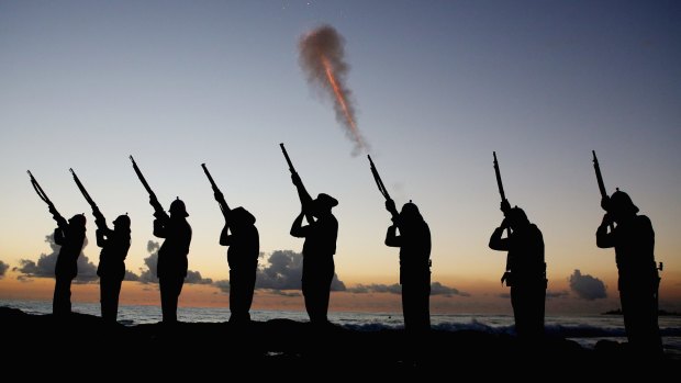 Members of the Albert Battery shoot a volley of fire during an ANZAC dawn service at Currumbin Surf Life Saving Club on the Gold Coast.