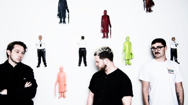 British band Alt-J in front of Michael Parekowhai's Kapa Haka and Over the Rainbow at the Art Gallery of NSW.
