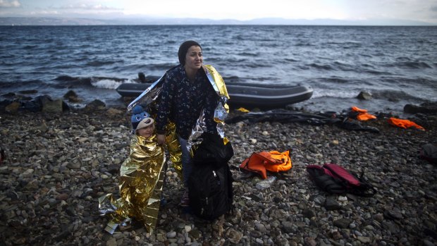 A Syrian woman and her child arrive on the Greek island of Lesbos after a perilous sea crossing from the Turkish coast in October last year.