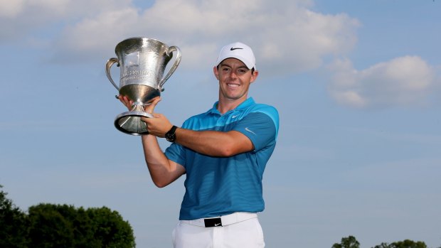 Rory McIlroy poses with the trophy.