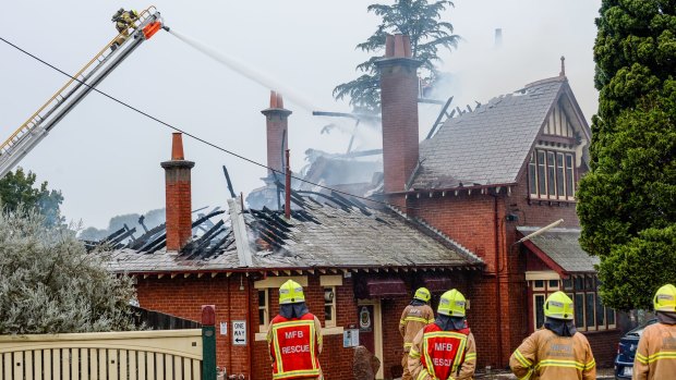 Firefighters assess the damage to the Ivanhoe RSL on Friday morning.