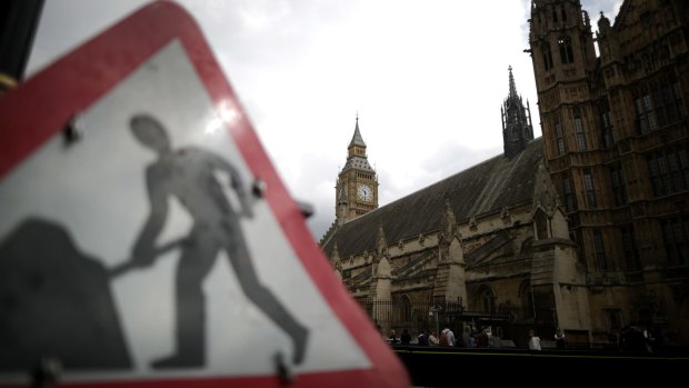 A 'beware roadworks' sign stands outside parliament as David Cameron holds his first cabinet meeting since Brexit.