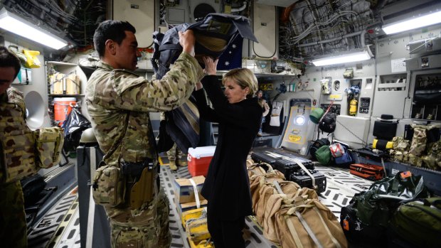 Foreign Affairs Minister Julie Bishop visits the Troops at KAIA-N base in Afghanistan. Bishop is helped into her body armour on the RAAF flight to Kabul.