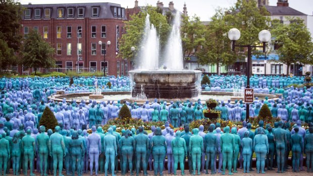People stand in a public park taking part in a mass nude art installation entitled Sea of Hull by New York based artist Spencer Tunick in Hull, England, Saturday July 9, 2016.