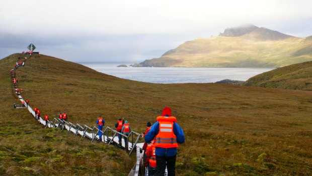 At Hoorn Island, passengers walk the hill toward the albatross memorial in honour of the 10,000 sailors who have died rounding Cape Horn.
